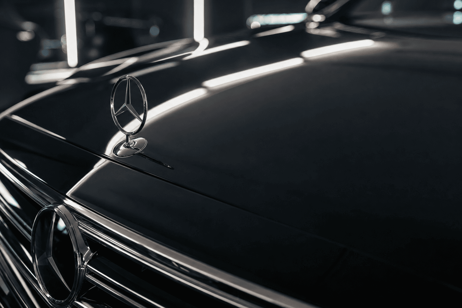 Close-up of a polished car hood with water droplets glistening